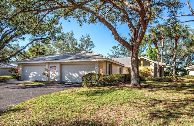 single story home with a garage and a front yard