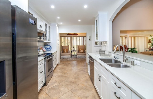 kitchen featuring white cabinetry, stainless steel appliances, sink, and decorative backsplash