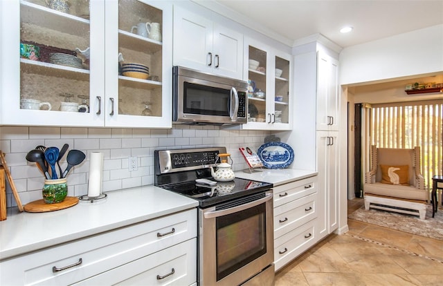 kitchen featuring white cabinetry, stainless steel appliances, and tasteful backsplash