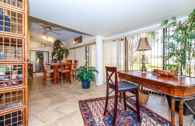 tiled dining space with ceiling fan and lofted ceiling