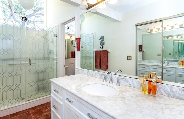 bathroom featuring vanity, an enclosed shower, and tile patterned flooring