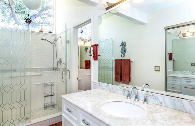 bathroom featuring vanity and a shower with shower door