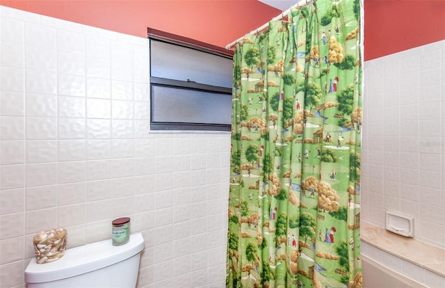 bathroom with tile walls, toilet, and shower / bathtub combination with curtain