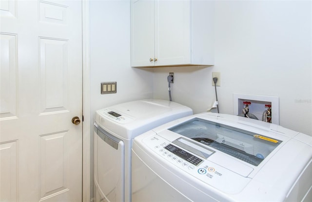 laundry area with cabinets and washer and dryer