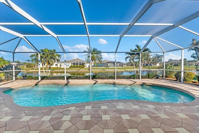 view of pool with a water view, a patio, and glass enclosure