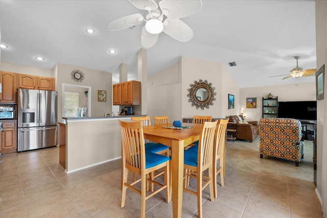 tiled dining room featuring vaulted ceiling and ceiling fan