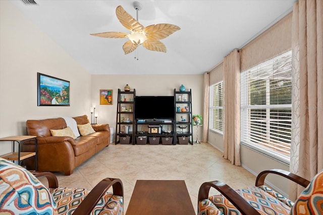 tiled living room featuring ceiling fan and vaulted ceiling