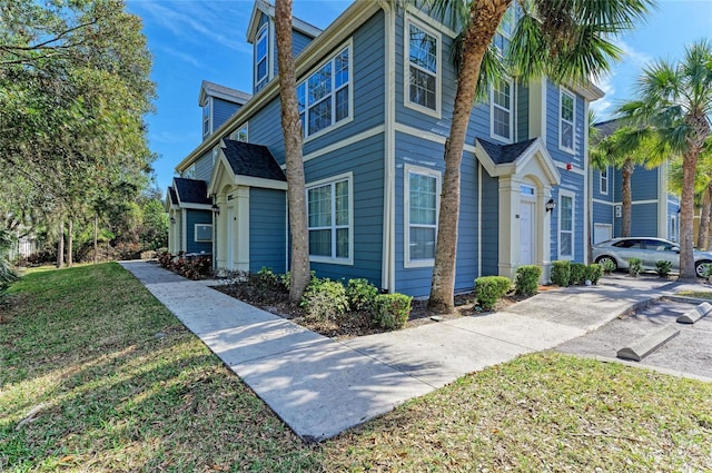 view of side of property with a lawn