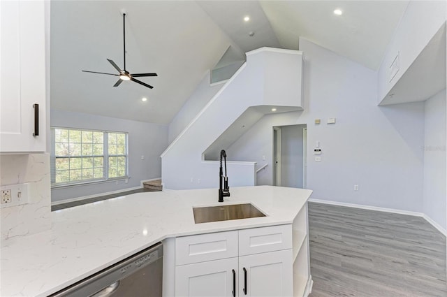 kitchen with white cabinetry, light stone countertops, sink, and stainless steel dishwasher