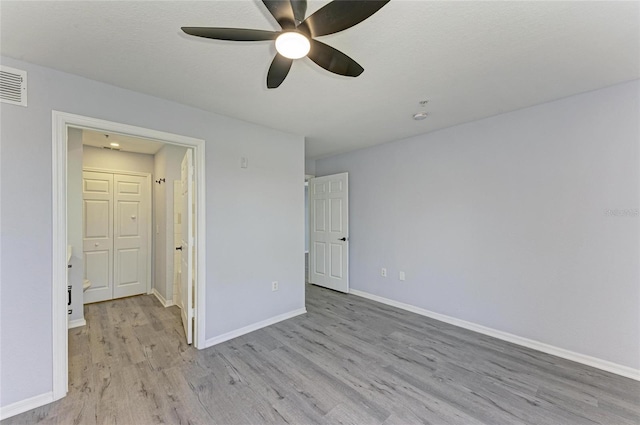 unfurnished bedroom featuring a textured ceiling, ceiling fan, and light hardwood / wood-style flooring