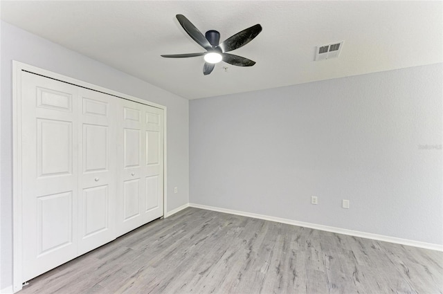 unfurnished bedroom with a closet, ceiling fan, and light hardwood / wood-style flooring