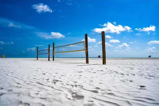 view of community featuring volleyball court, a beach view, and a water view