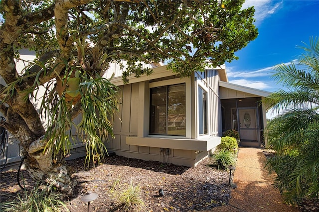 view of home's exterior with a sunroom