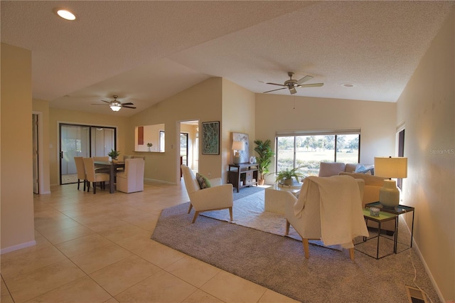 tiled living room with ceiling fan, lofted ceiling, and a textured ceiling