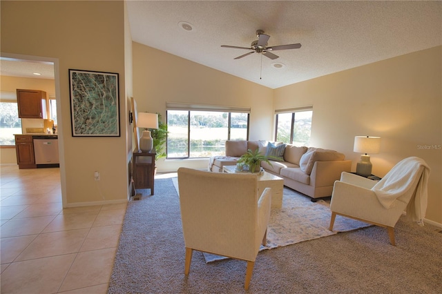 tiled living room with plenty of natural light, high vaulted ceiling, and ceiling fan