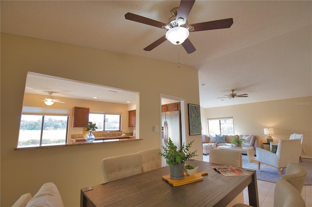 tiled dining area with lofted ceiling