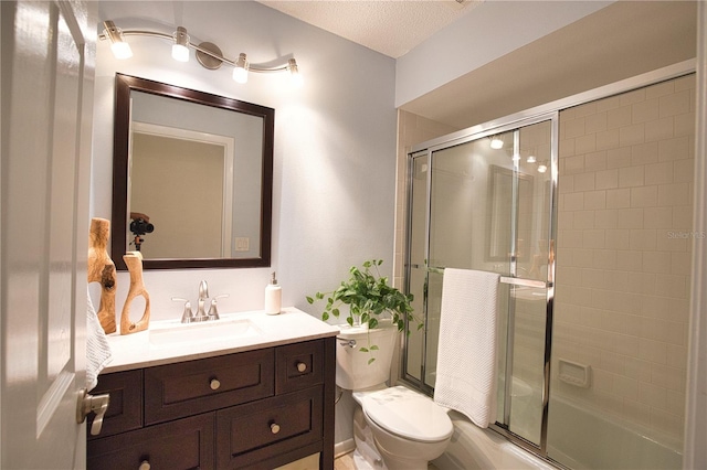 bathroom featuring vanity, a textured ceiling, and toilet