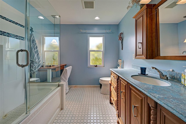 bathroom featuring vanity, an enclosed shower, and toilet