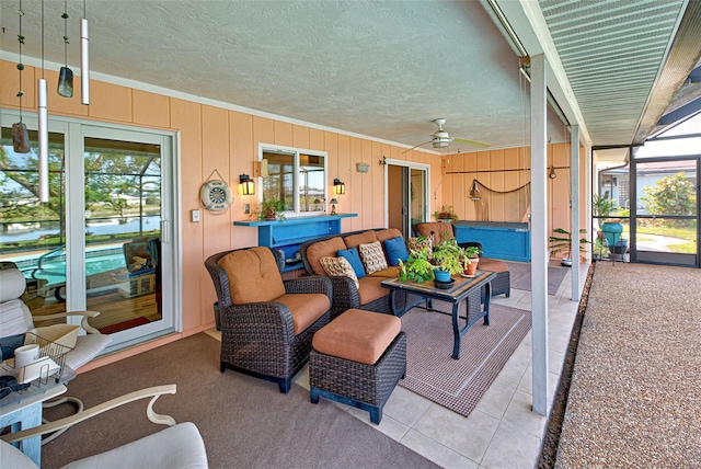 exterior space with a lanai, outdoor lounge area, ceiling fan, and a jacuzzi