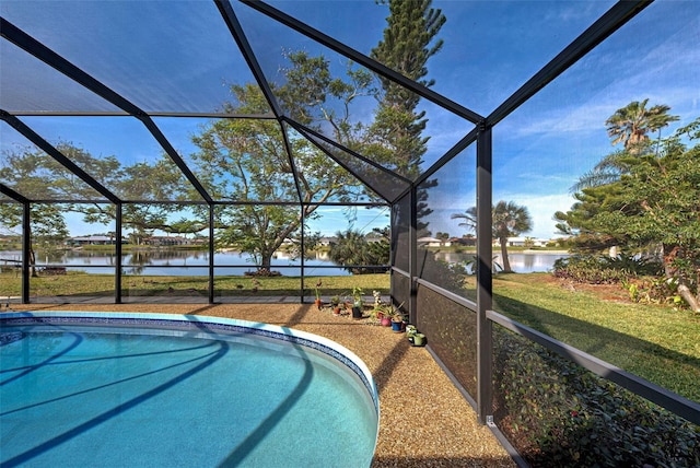 view of swimming pool with a water view, a yard, and glass enclosure