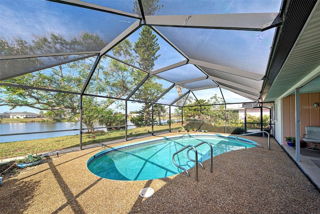 view of pool featuring a patio, a water view, and glass enclosure