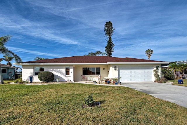 single story home featuring a garage and a front lawn