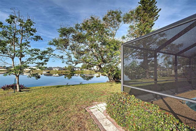 view of yard featuring a water view and a lanai