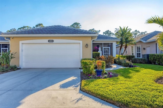 single story home featuring a garage and a front lawn