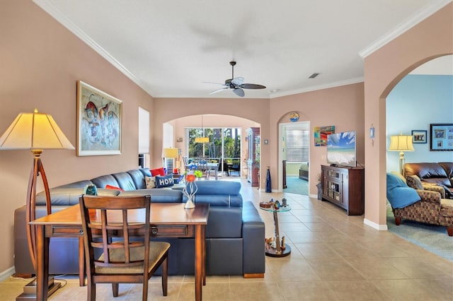 living room with light tile patterned flooring, ceiling fan, and ornamental molding