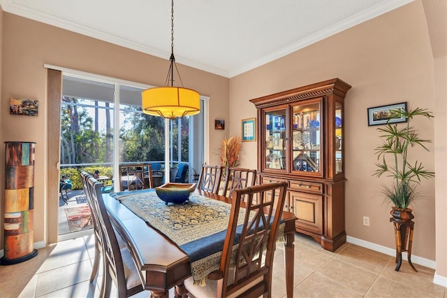 dining room with ornamental molding and light tile patterned floors