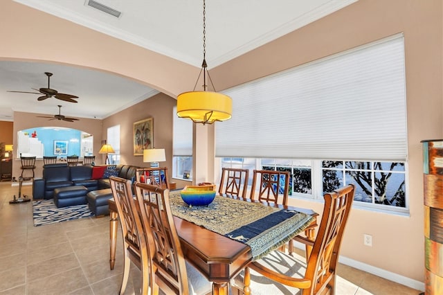 tiled dining room featuring ornamental molding