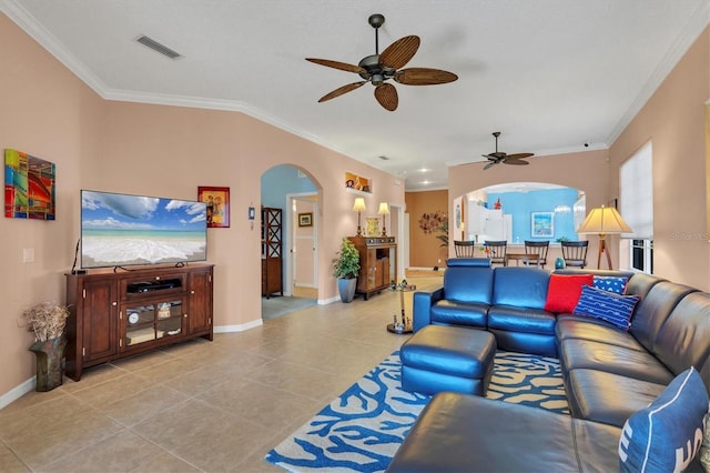 living room with ceiling fan, ornamental molding, and light tile patterned floors