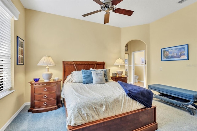 carpeted bedroom featuring ensuite bath and ceiling fan