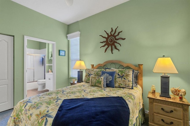 carpeted bedroom featuring connected bathroom