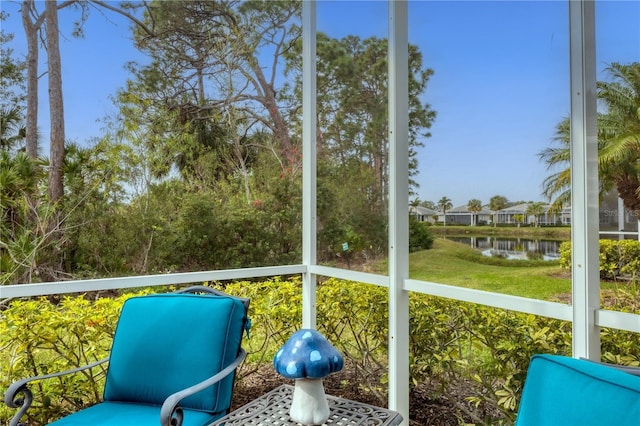 unfurnished sunroom featuring a water view