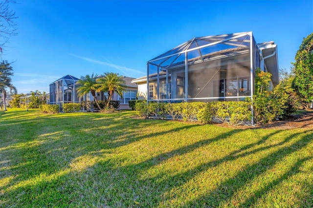 view of yard with glass enclosure