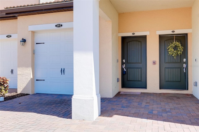 doorway to property with a garage