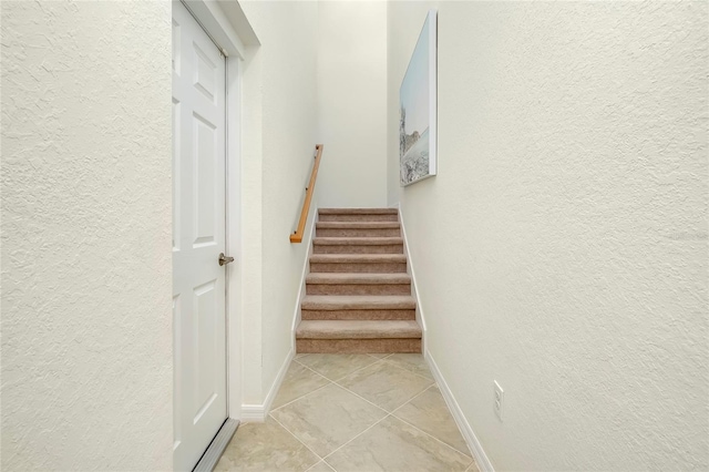 staircase featuring tile patterned floors