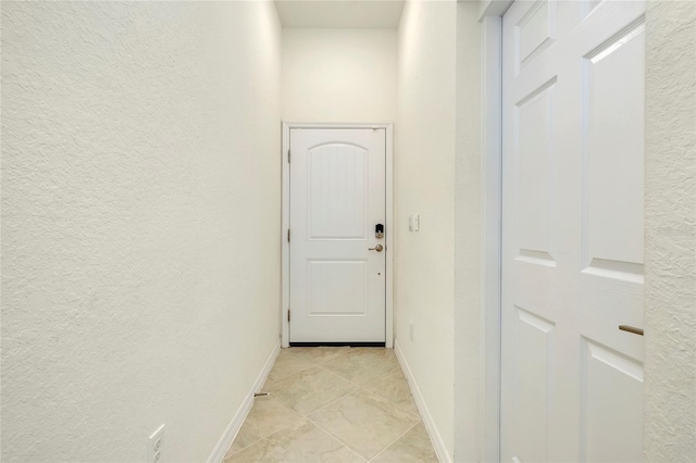 corridor featuring light tile patterned floors