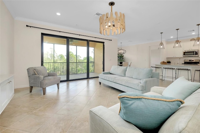 living room featuring light tile patterned floors, ornamental molding, and a chandelier