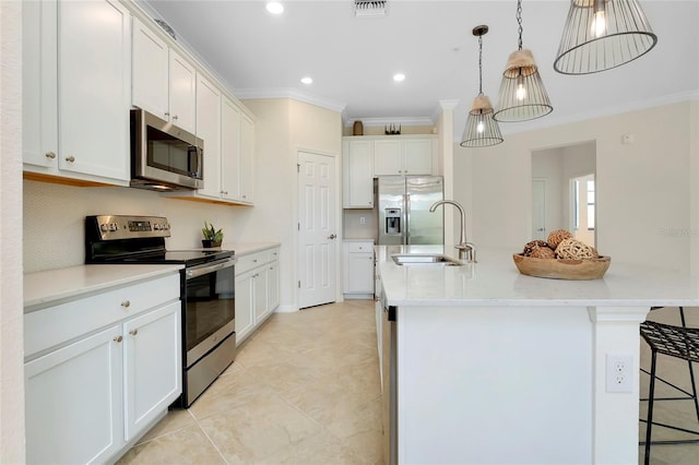 kitchen featuring sink, white cabinetry, decorative light fixtures, an island with sink, and stainless steel appliances