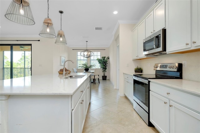 kitchen with appliances with stainless steel finishes, sink, a kitchen island with sink, and white cabinets