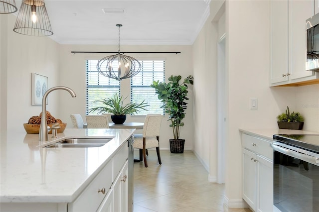 kitchen with pendant lighting, sink, appliances with stainless steel finishes, a notable chandelier, and white cabinets