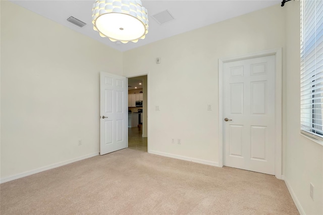 carpeted empty room with a wealth of natural light