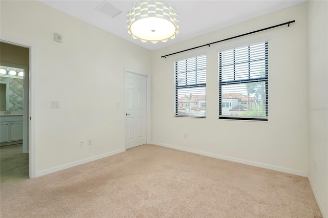 unfurnished room with light carpet