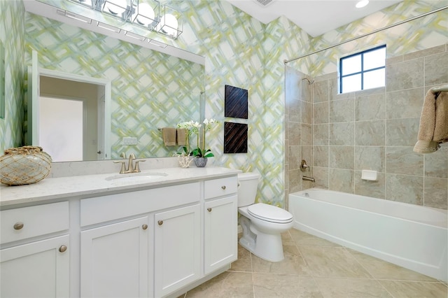 full bathroom featuring tile patterned floors, vanity, toilet, and tiled shower / bath combo