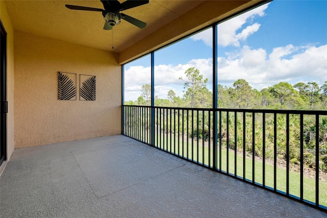 sunroom / solarium featuring ceiling fan