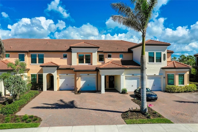 mediterranean / spanish house with a garage