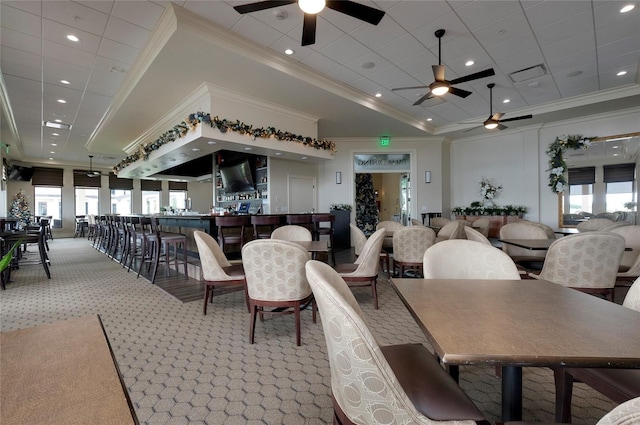 dining space with crown molding, a wealth of natural light, and light colored carpet