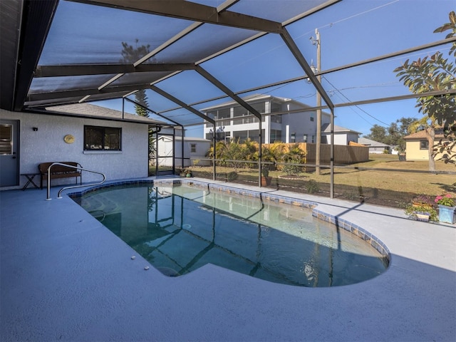 view of swimming pool featuring a lanai and a patio